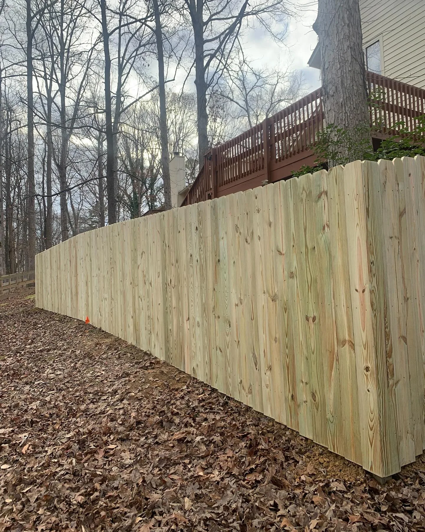 New wooden privacy fence installed by Chesterfield Fencing & More in a Virginia Beach backyard.