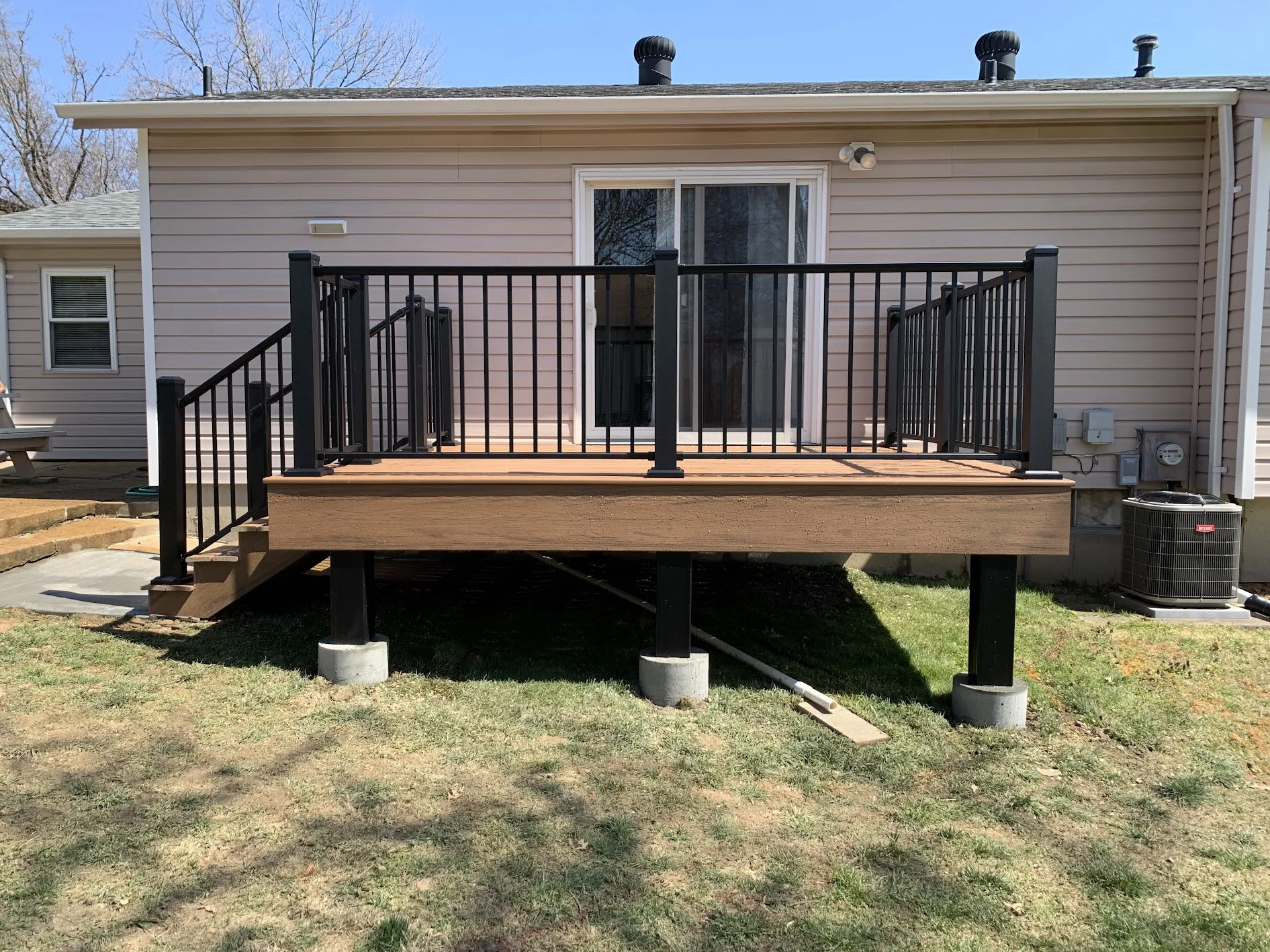 Elevated deck with visible drainage space underneath, showcasing a deck drainage solution by Chesterfield Fencing in Virginia Beach.